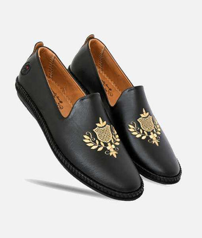 Black men's ethnic mojari shoes with gold embroidered floral design and synthetic leather upper